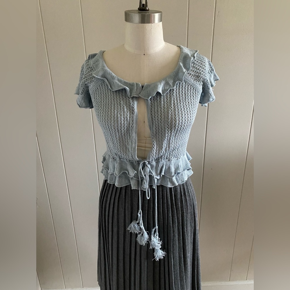 Femme pointelle cardigan with knitted flounces and peplum.
